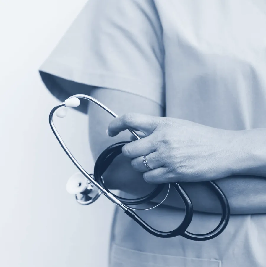 Clinician holding a stethoscope