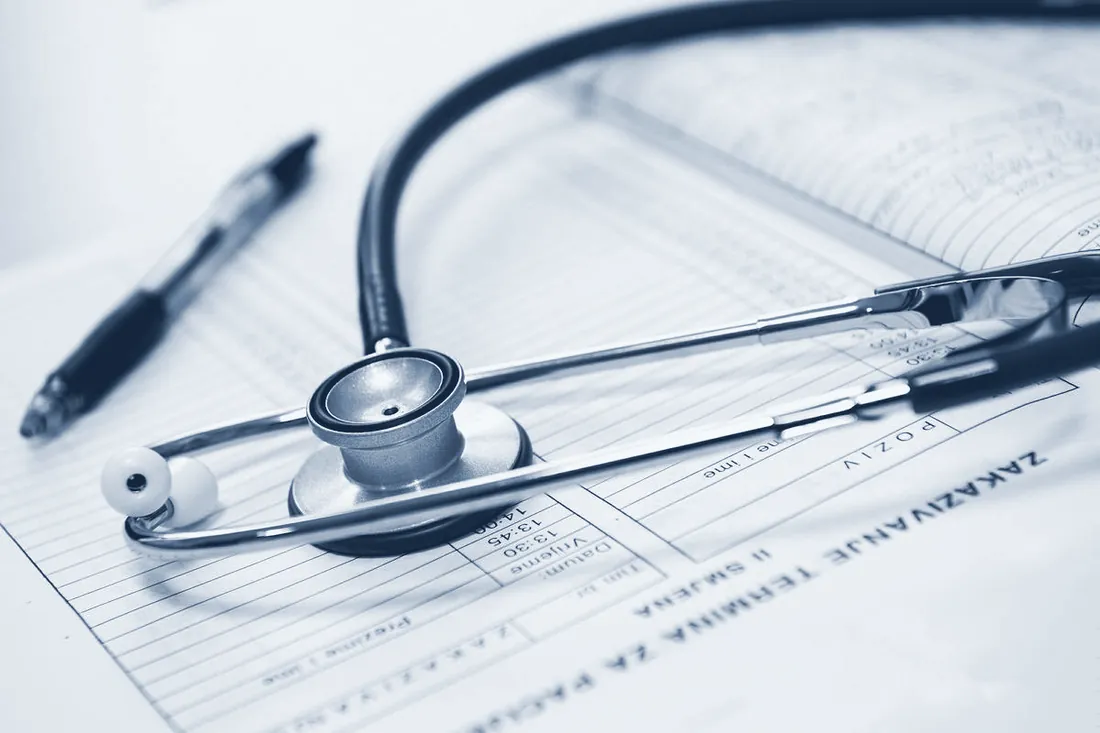 Stethoscope and pen on clinical notes